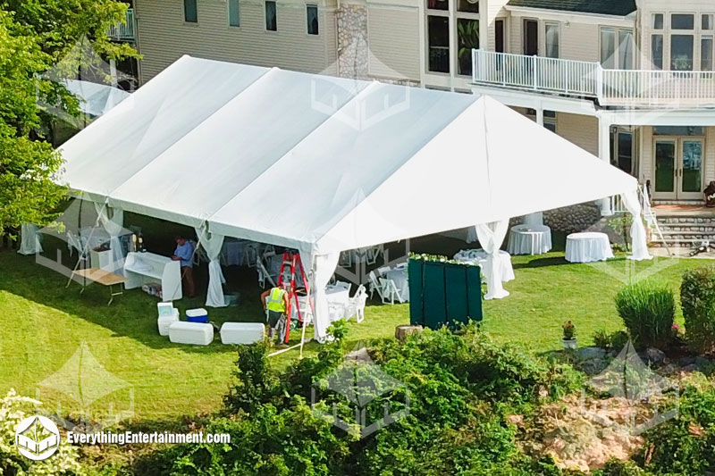 40x45 foot wedding tent setup in backyard with house in background