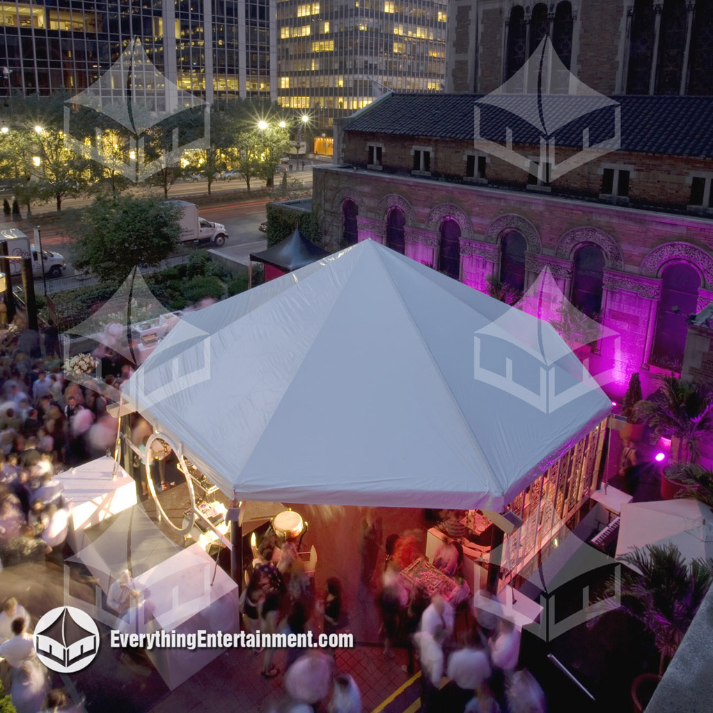 A large octagon tent setup at St Barts Church in NYC with magenta LED lighting