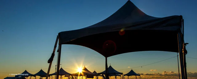 multiple high peak tent rentals at sunrise
