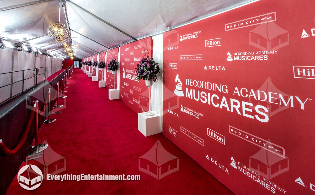 Interior view of the 15x150 arrivals tent showing Kino Flo theatrical lighting, stanchions, and press risers outside Radio City Music Hall in NYC.