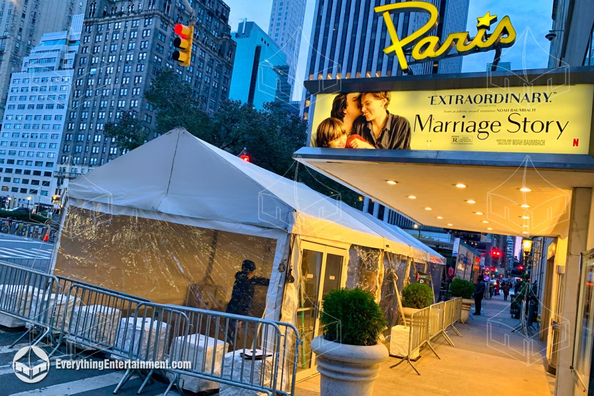 A 15x50 frame tent with clear sidewalls, double doors, and custom subflooring installed on the NYC sidewalk outside the Paris Theater for the Marriage Story movie premiere by Everything Entertainment.