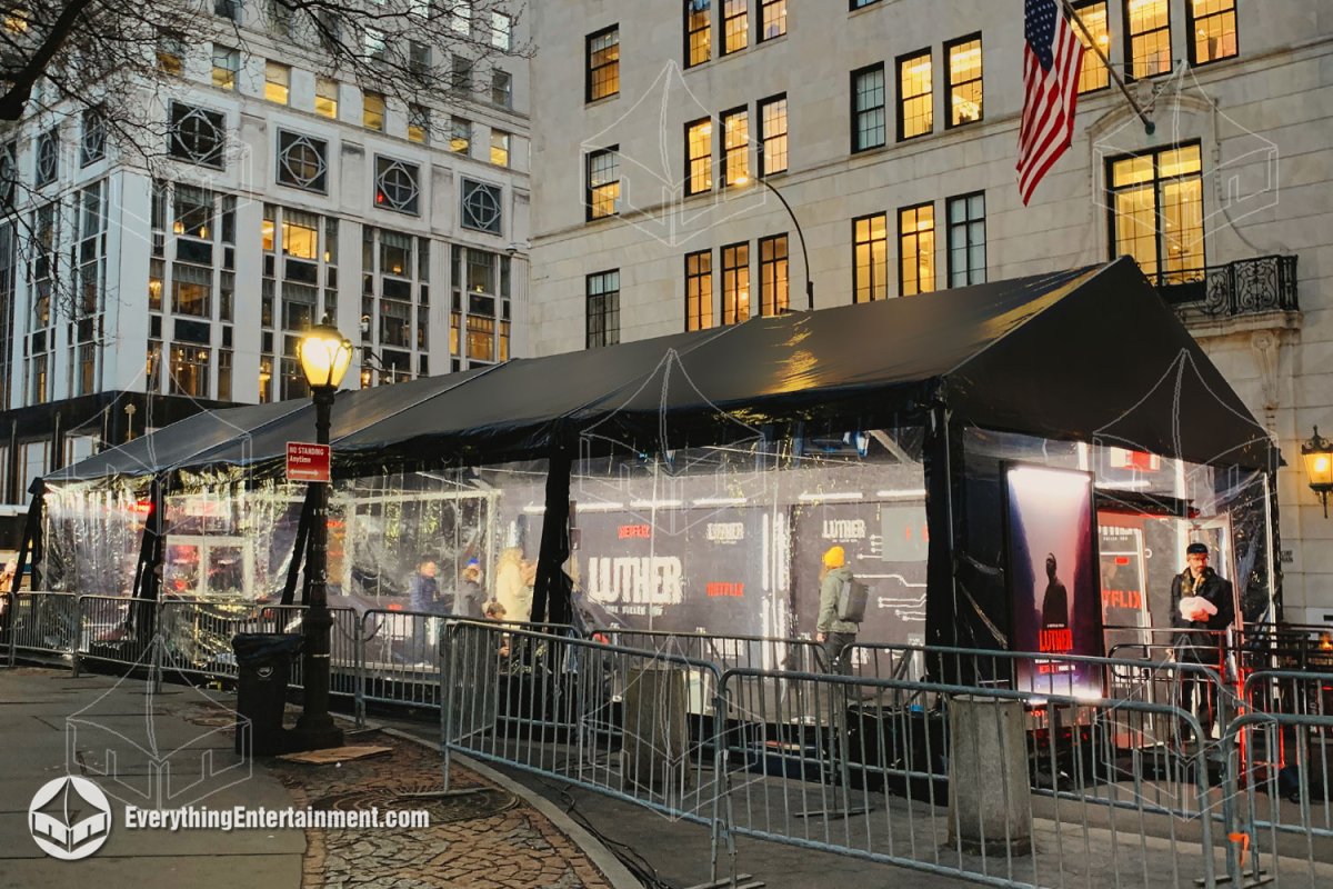 A 20x60 black top maxi-frame tent with clear sidewalls, subfloor, and electric heaters installed by Everything Entertainment in front of the Pulitzer Fountain for the Luther movie premiere in NYC.