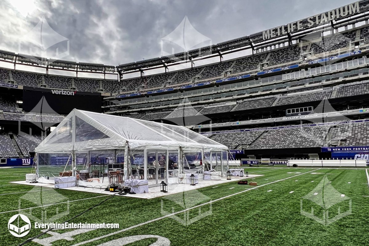 A 30x40 clear top frame tent with subfloor, clear sidewalls, and heating installed directly on the field at MetLife Stadium by Everything Entertainment.