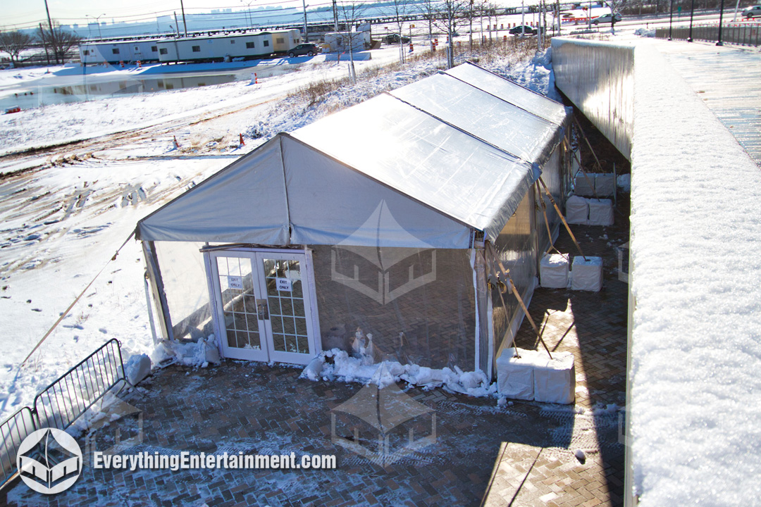 A 30x45 foot frame tent was set up in the snow, along with tent heaters