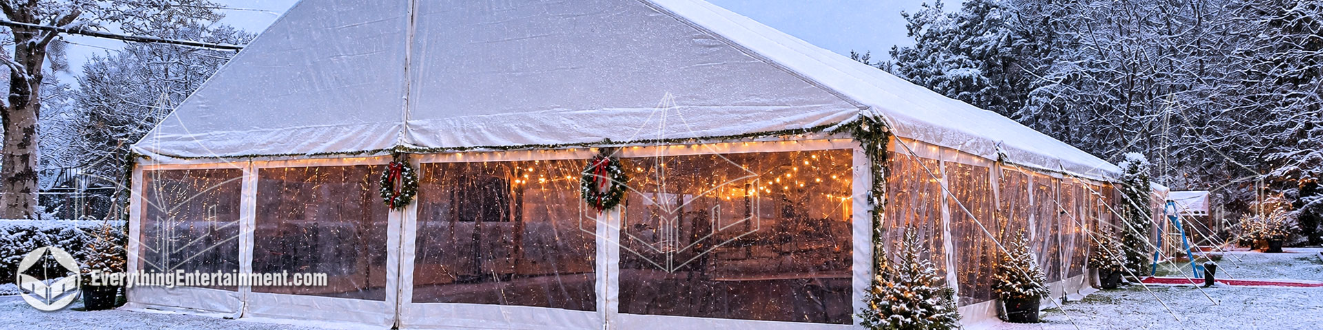 40x100 white frame tent with sidewalls and warm lighting installed for a winter holiday party