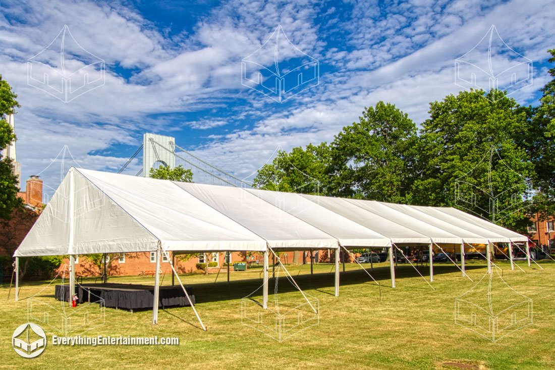 A 40x200 white maxi-frame tent installed on the grass at Fort Wadsworth on Staten Island with the Verrazzano-Narrows Bridge in the background by Everything Entertainment.