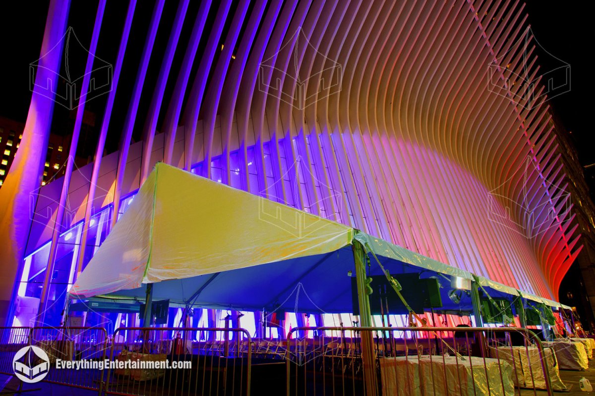 A 40x50 white frame tent illuminated by purple and red architectural lighting, set up by Everything Entertainment outside The Oculus at the World Trade Center in NYC for a 9/11 Memorial VIP event.