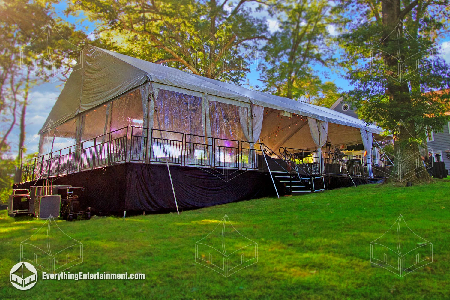 A 40x60 event tent installed on top of a raised and leveled sub-floor in a residential backyard