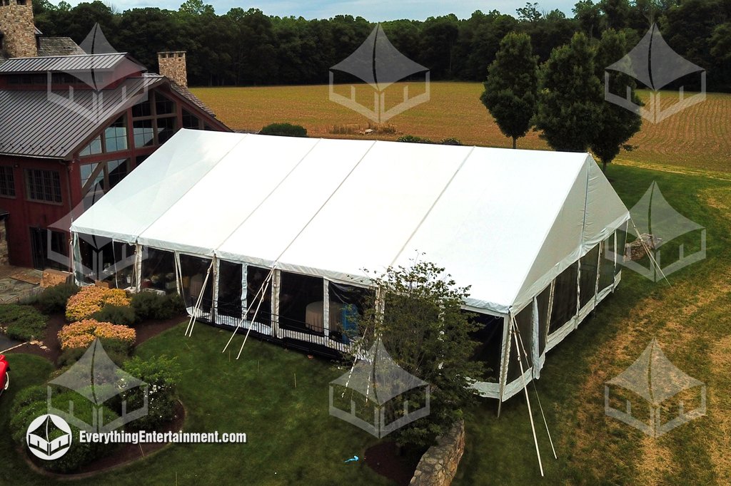 High-angle aerial view of a 50x70 maxi frame wedding tent with clear sidewalls and a custom leveled subfloor installed in a Glen Gardner NJ backyard by Everything Entertainment.