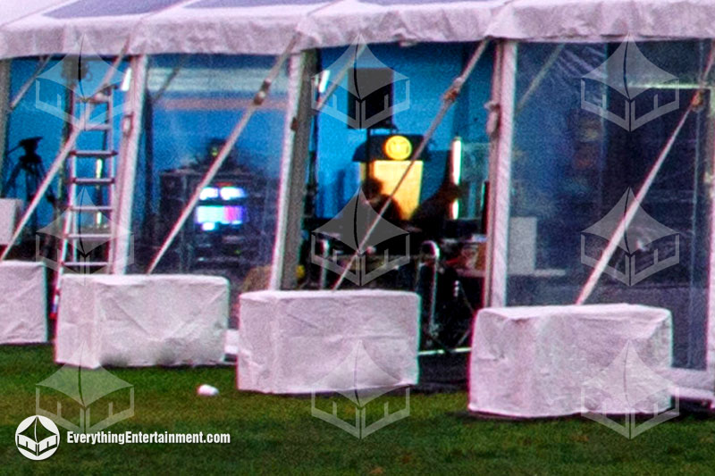 Cement Tent Anchor Ballasts connected to a large frame tent on grass