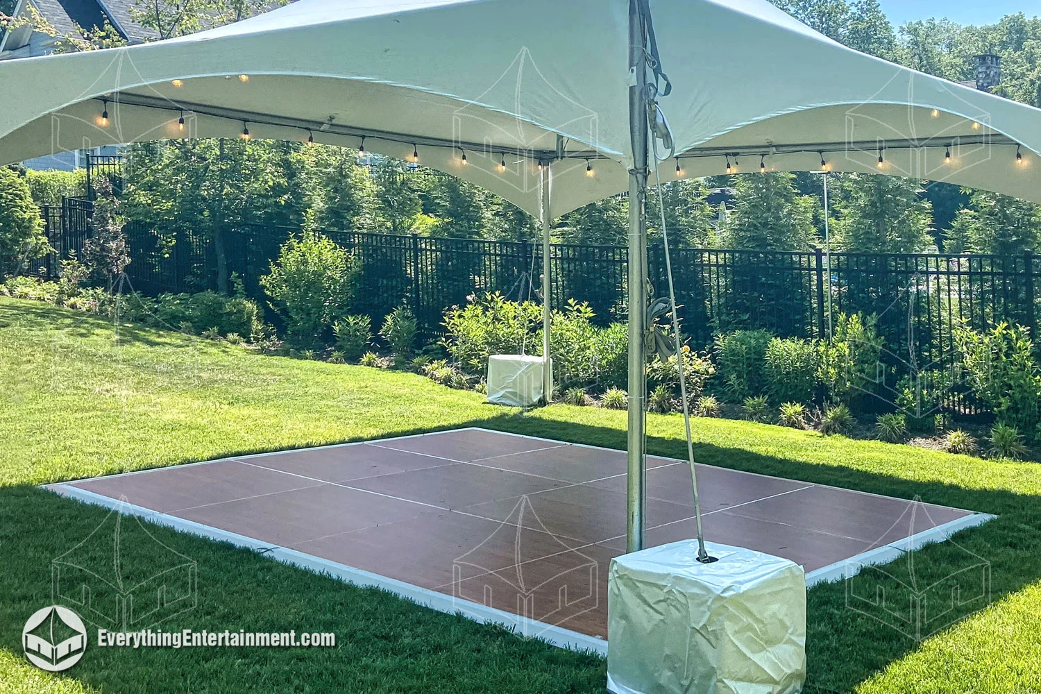 A 12x16 Dance Floor underneath a 20x20 High Peak Tent.