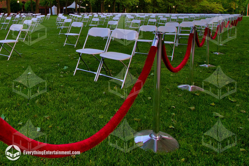 chrome stanchions setup on grass at graduation