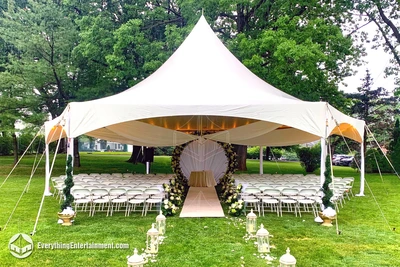 hexagon shaped high peak tent rental with chairs setup for ceremony at Richmond County Country Club in Staten Island, NY