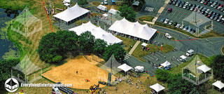 An aerial view of many large and small tents plus inflatable amusements