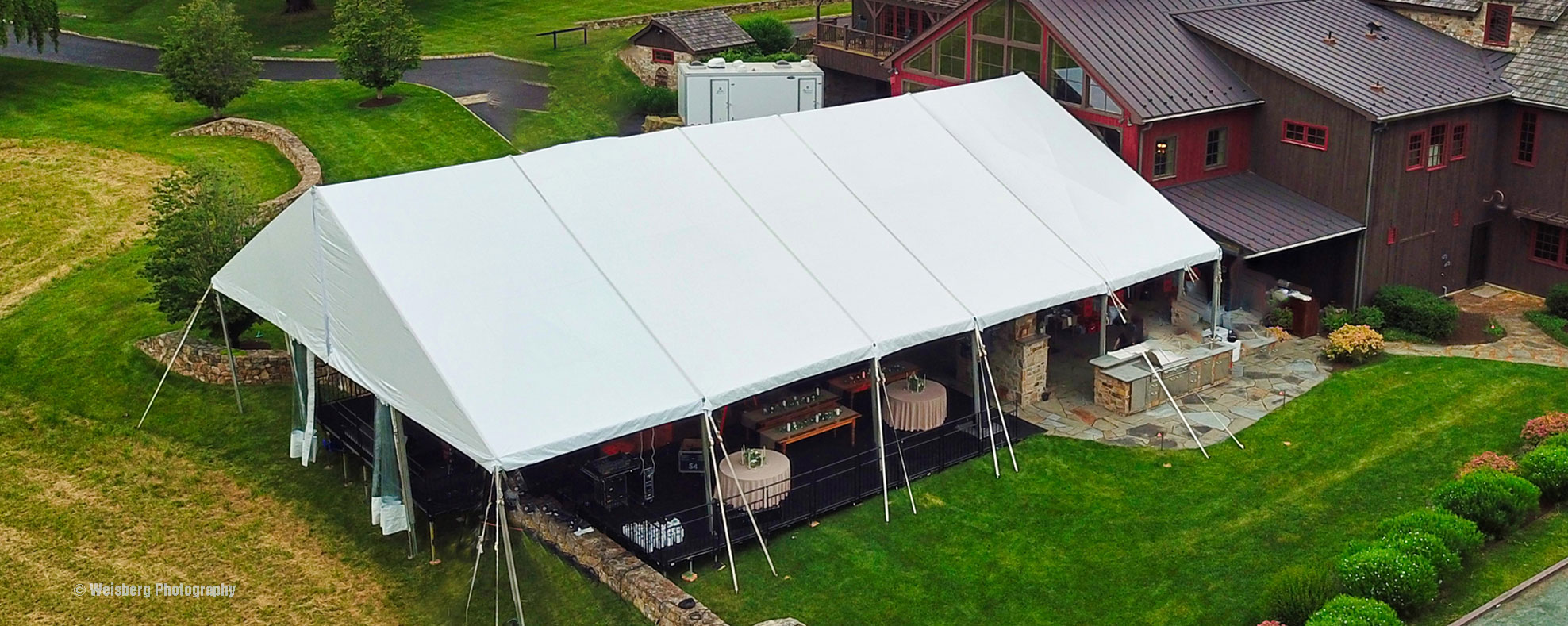 A large frame tent connected to house