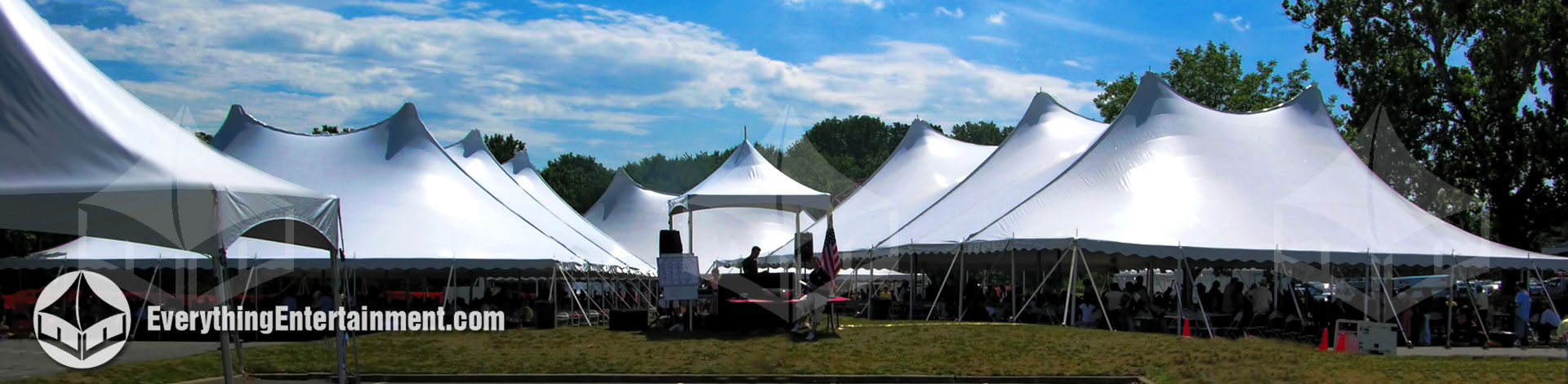 Large tension tents with blue sky and clouds