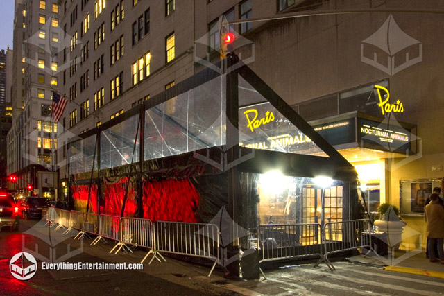 A mono-pitch tent with clear tops and black trim in front of the Paris Theater in NYC for a movie pr