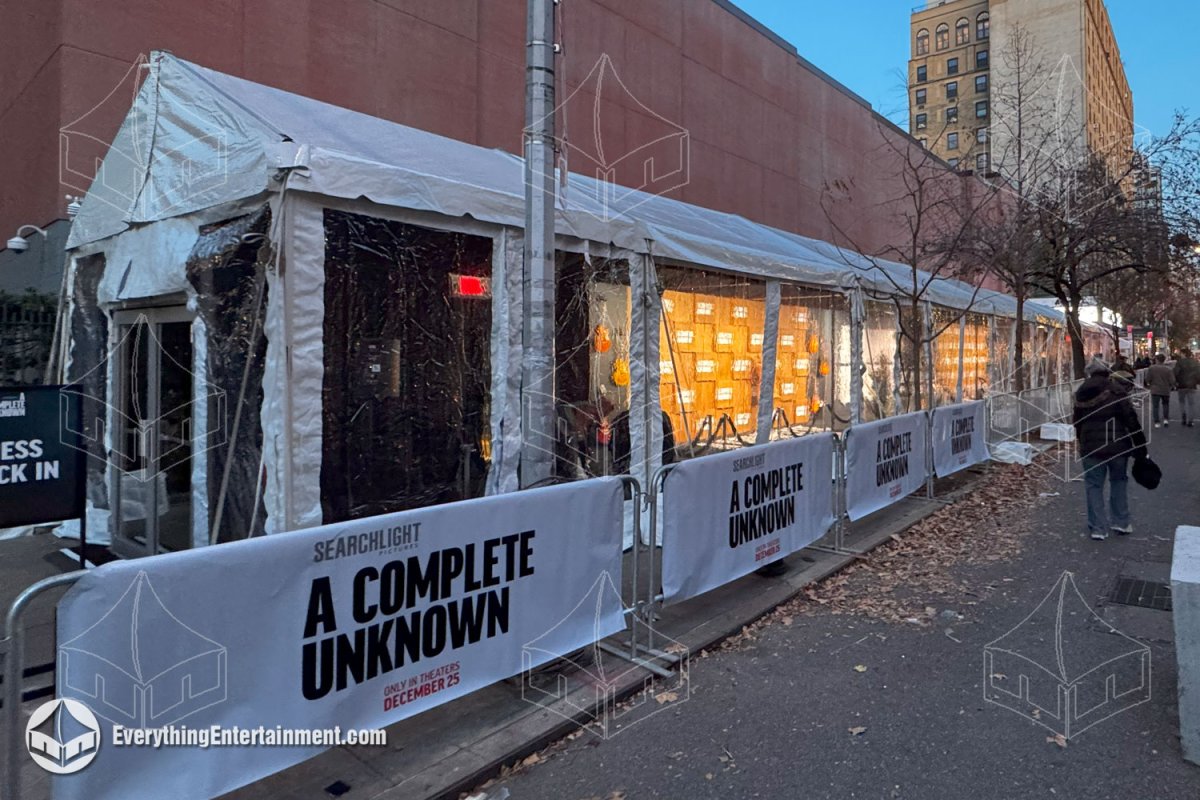 A 15x125 maxi-frame premiere tent with clear sidewalls and branded barricade covers installed on the sidewalk outside SVA Theatre in NYC by Everything Entertainment.