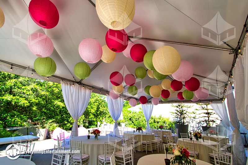 20x40 white top frame tent with colorful paper lanterns, tent leg drapes and party rentals