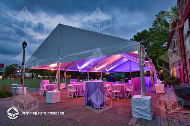 30x60 frame tent rental with colorful led event lighting and party rentals, setup on a stone floor