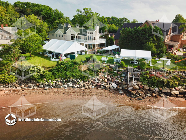 Aerial view of Wedding Tents on a cliff right off the water.
