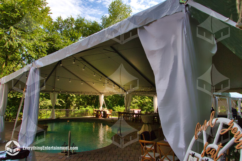 A large frame tent setup over a pool in a New Jersey backyard