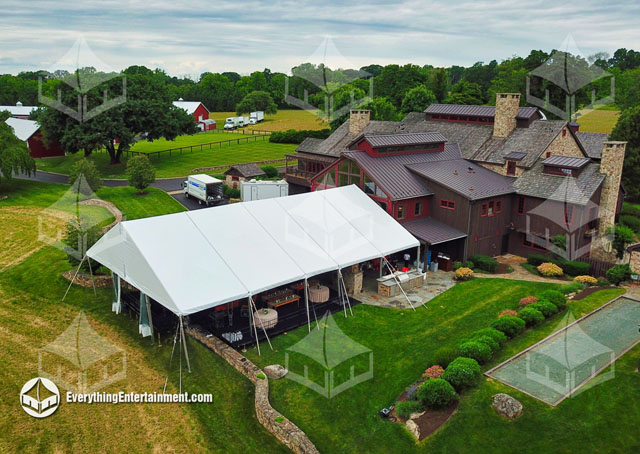 A 50x70 Wedding Tent attached to a large farm house for a backyard wedding.