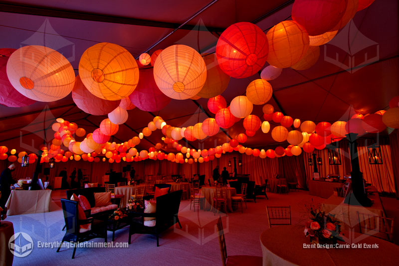 A large wedding tent with white turf, temporary flooring, and lots of paper lanterns, setup in NJ