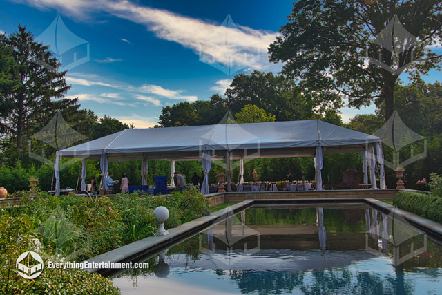 party tent in courtyard with reflection in decorative pool.