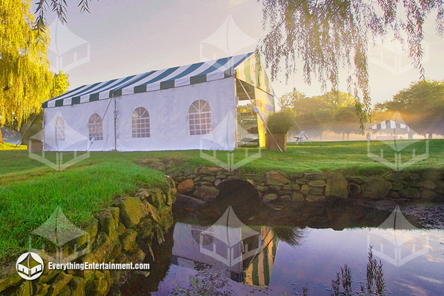 A green and white tent setup for a corporate golf outing