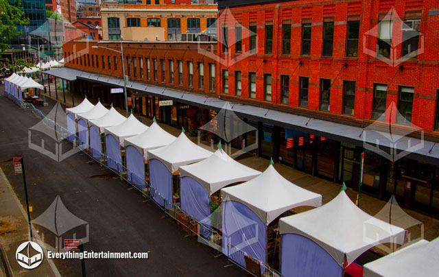 A long line of 10x10 High Peak Tents setup on a NYC street for a festival.