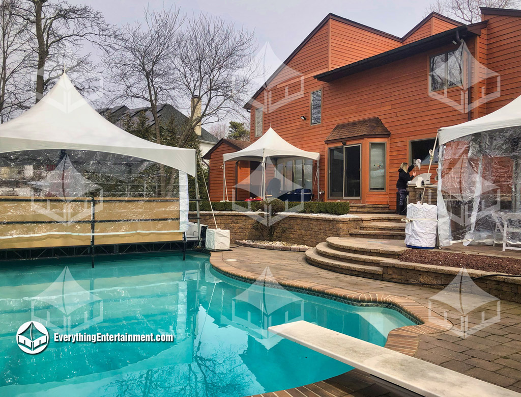 High Peak Tents in a backyard with a pool in the foreground.