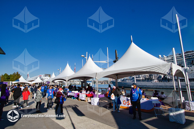 Many high-peak marquee tents on the pier at the Intrepid Sea, Air, Space Museum in NYC for a charity walk.