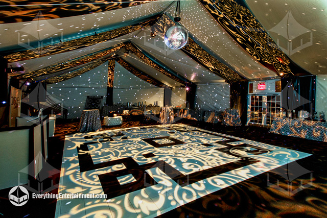 40x75 white frame tent with baroque black and white dance floor and event lighting.
