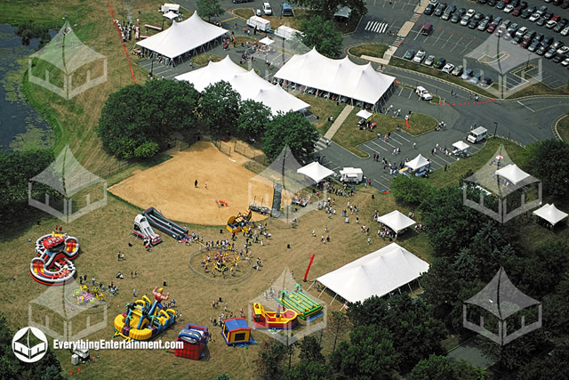 Aerial view of many large tents for a company picnic.