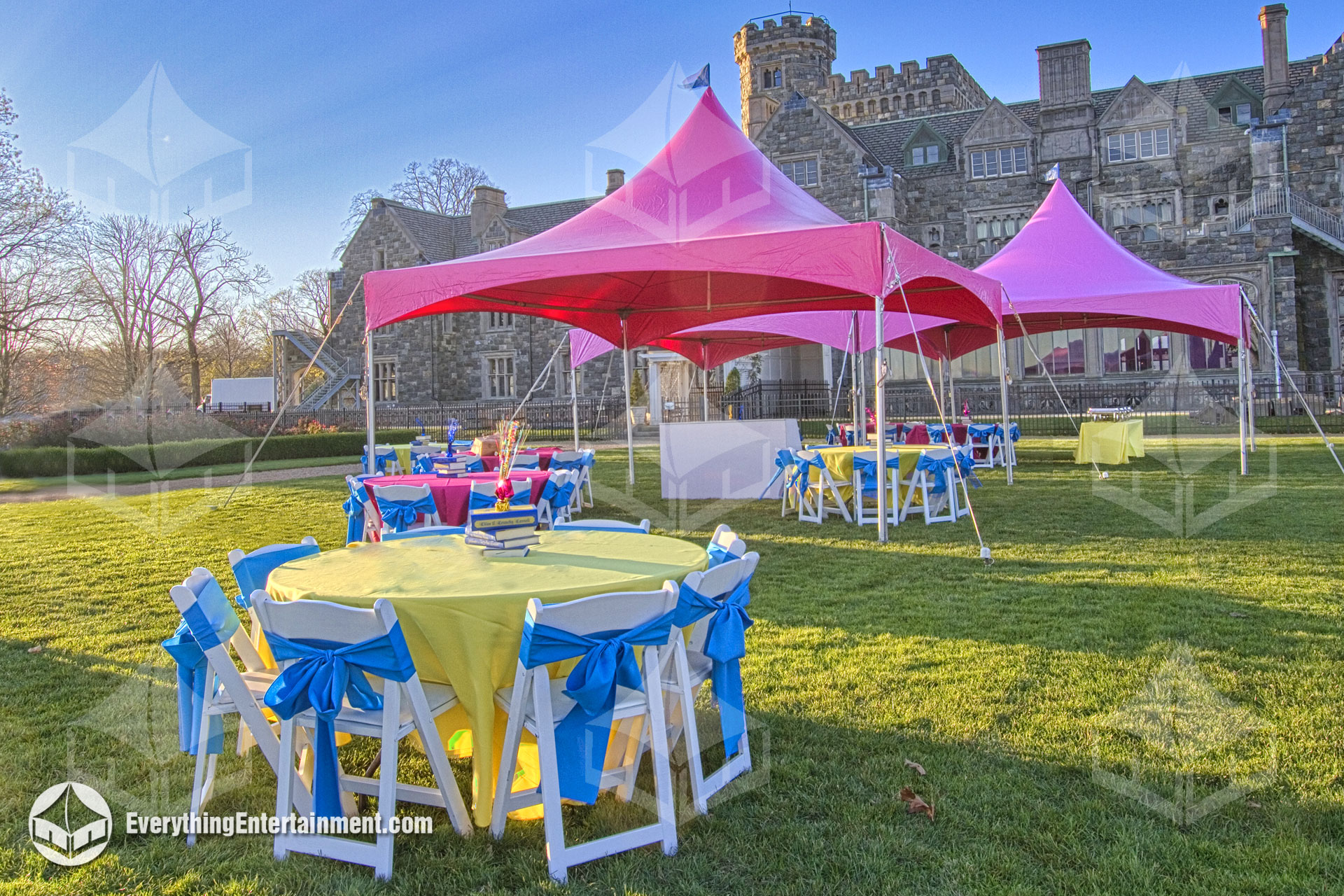 Pink high-peak tents, tables, chairs, and linens for private party