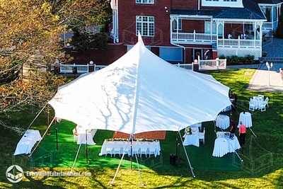 A 44-foot round sailcloth tent in a Staten Island, NY backyard for a wedding