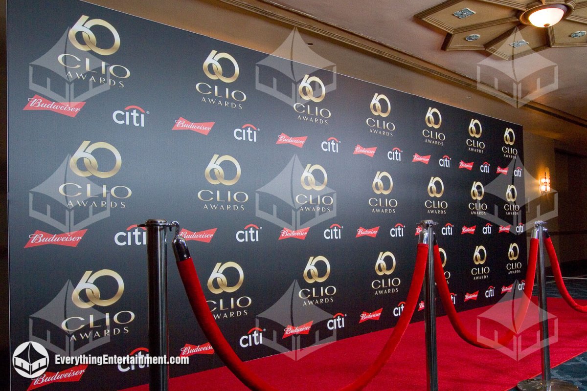Premium SEG fabric step and repeat wall with Clio Awards branding, red carpet, and chrome stanchions with red velvet ropes installed by Everything Entertainment in NYC.