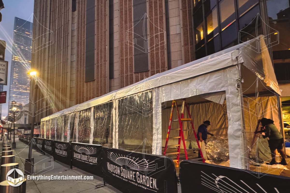 A 20x75 white frame tent with clear sidewalls installed along the sidewalk outside Madison Square Garden in NYC by Everything Entertainment.