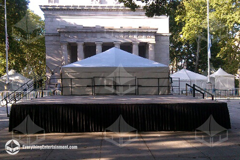 Portable stage with black railing and skirts setup in front of General Grants National Memorial