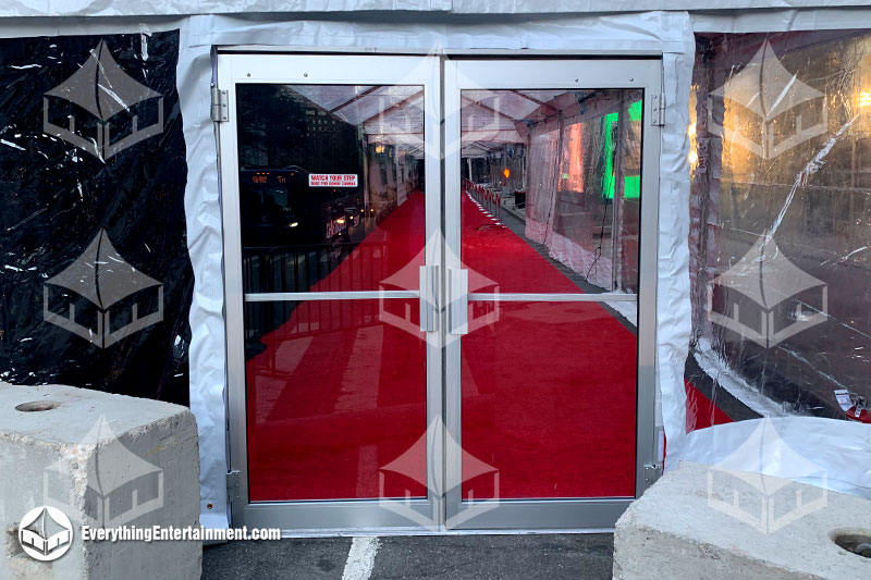 double clear doors on tent with red carpet inside