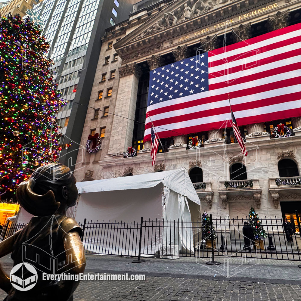 Tent at NY Stock Exchange with Fearless Girl Frame Tent set up at the New York Stock Exchange with statue of Fearless Girl looking at American Flag