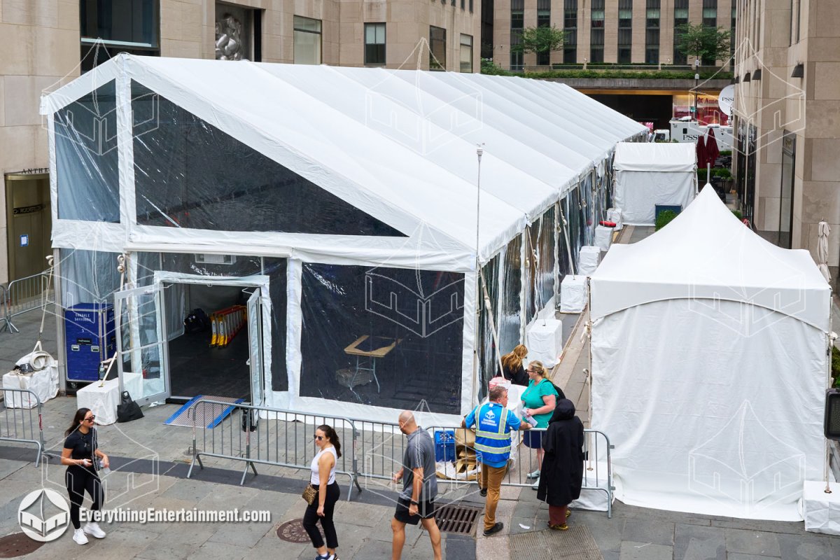 Exterior view of a 25x180 mono pitch frame tent with glass doors and concrete ballasts installed at Rockefeller Center for the Tony Awards by Everything Entertainment.