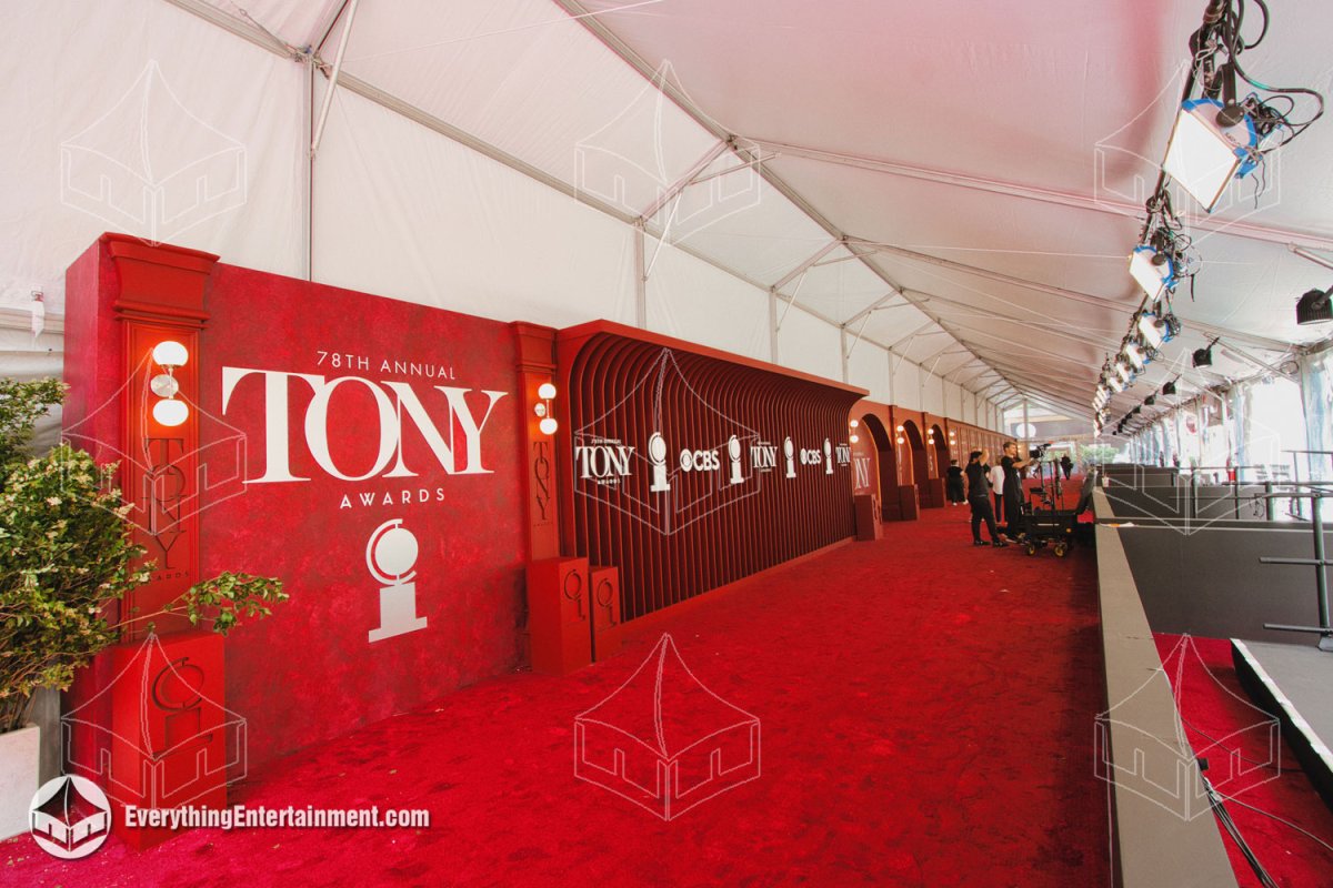 Interior view of the 25x180 mono pitch red carpet arrival tent with carpeted subfloor, lighting rigging, and Tony Awards backdrop build by Everything Entertainment.