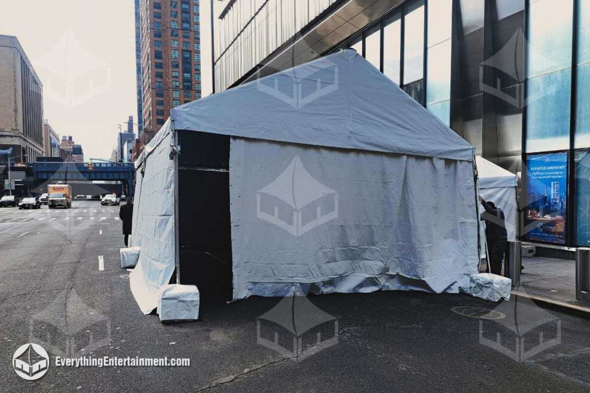 A 20x30 vehicle drive-through screening tent installed along a city street curb in NYC by Everything Entertainment.
