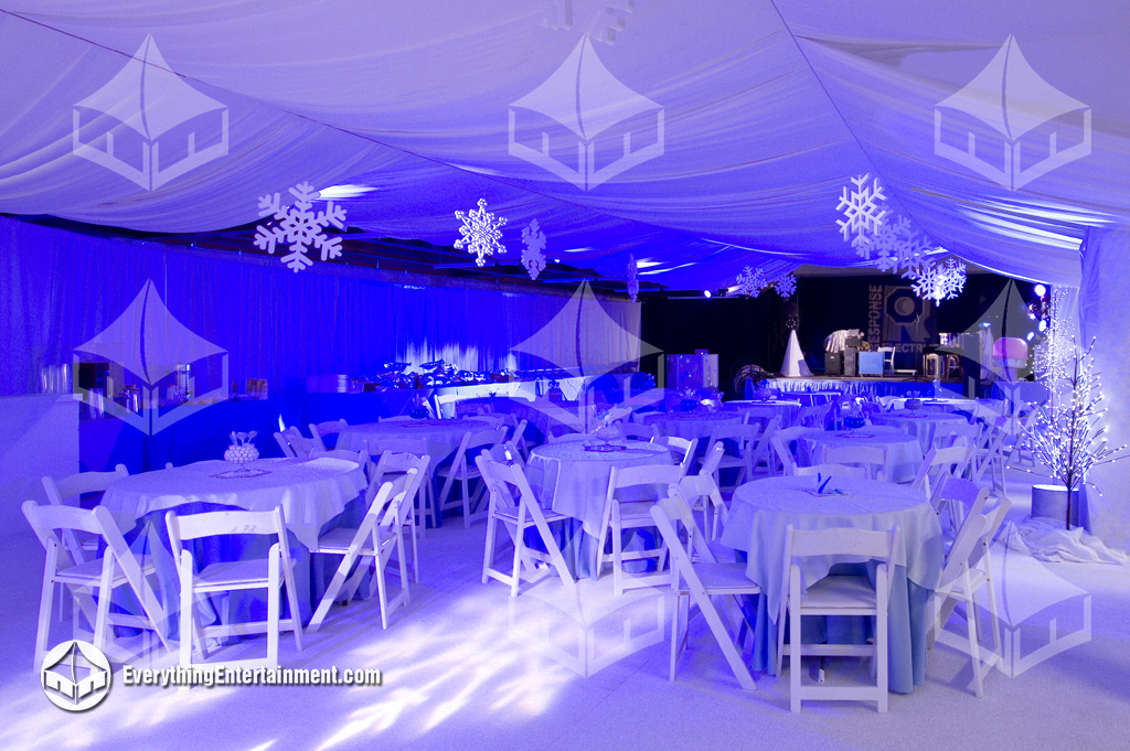 Drapery, tables and chairs, blue lighting, and giant snowflake ornaments fo