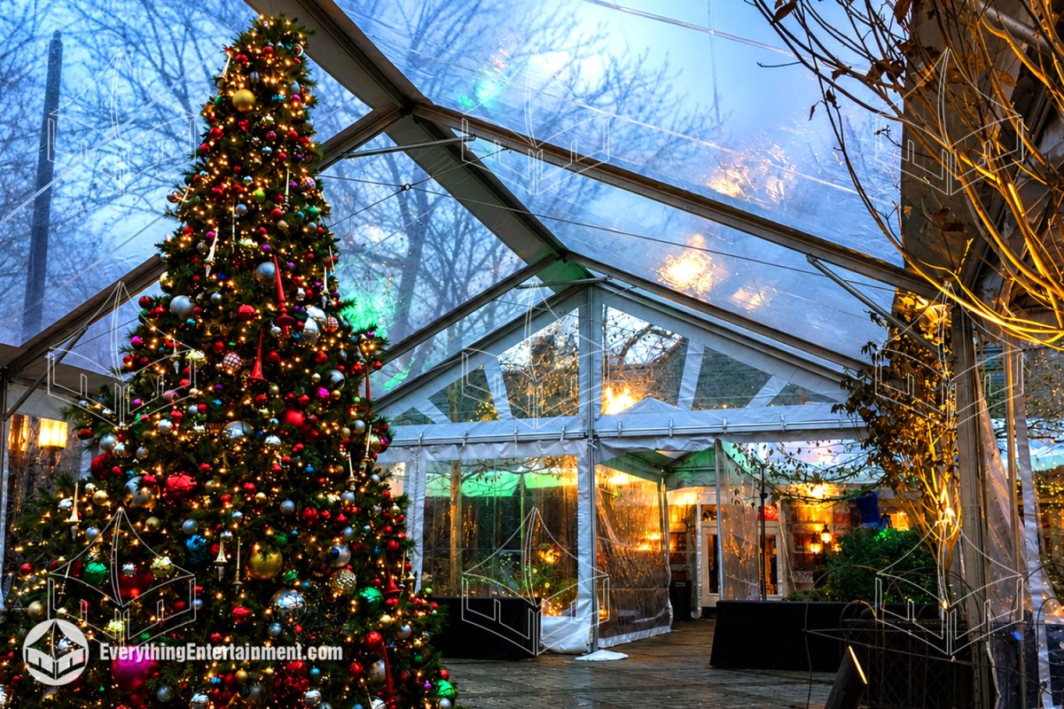 A giant decorated holiday tree glowing inside a 30x54 clear top frame tent with clear sidewalls and tent heaters installed by Everything Entertainment at Tavern on the Green in Central Park, NYC.